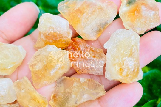 raw yellow citrine crystal on hand outdoor shooting