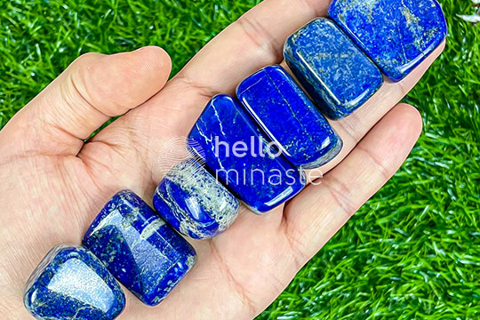 blue tumbled lapis lazuli healing crystal on hand