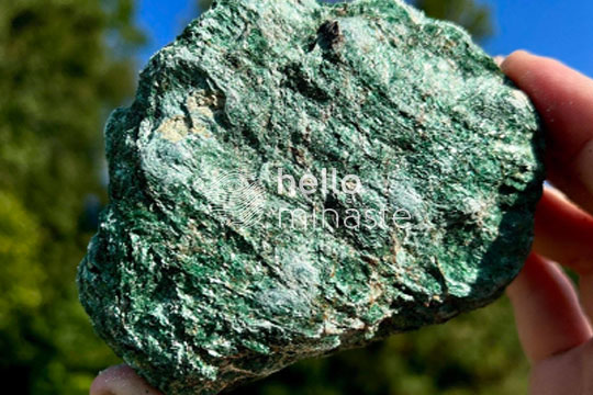 green raw fuchsite crystal on hand outdoor photography