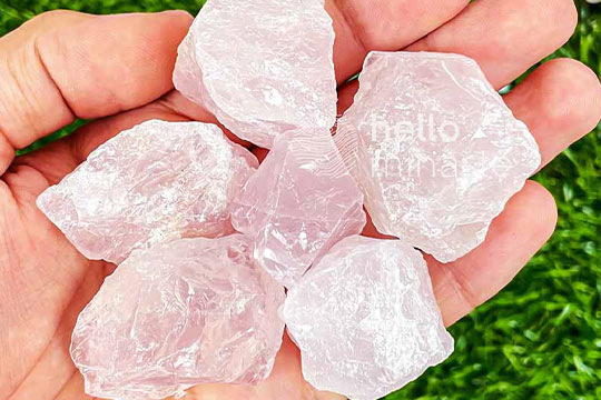raw rose quartz on hand pink healing crystal