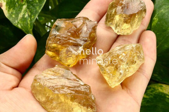 raw yellow topaz crystal on hand