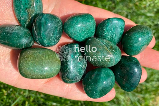 green tumbled fuchsite stone on hand outdoor photography